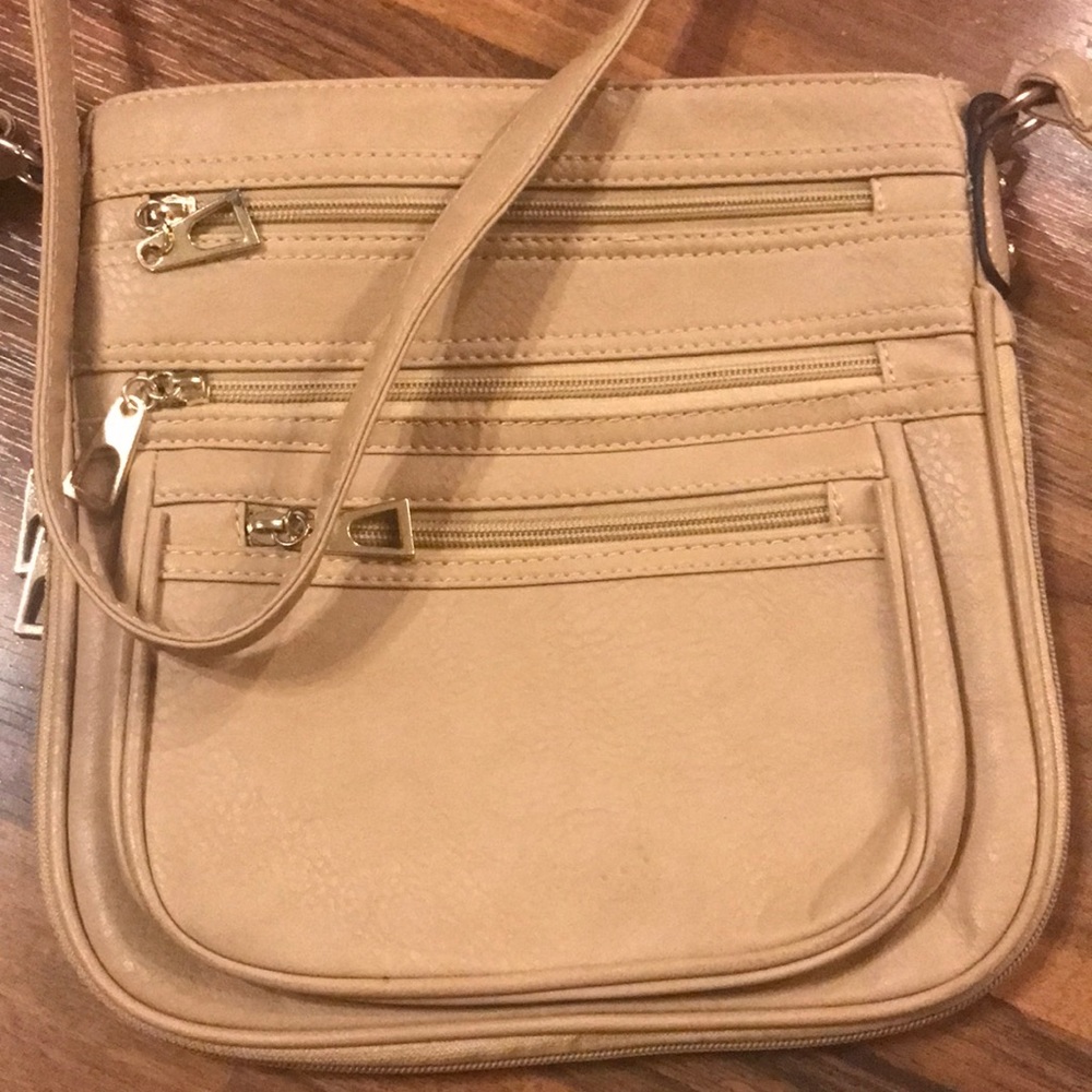 Beige purse with many compartments.